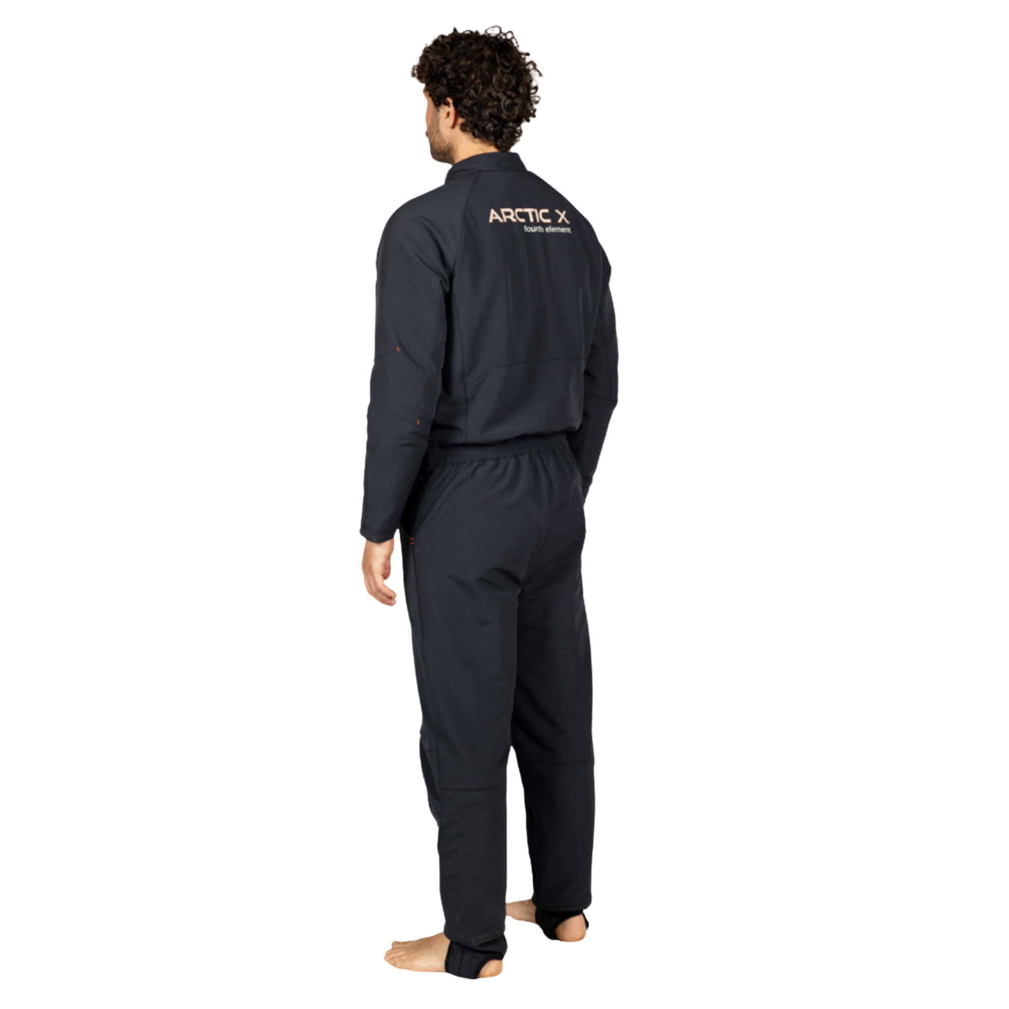 A man wearing a dark Arctic one piece, viewed from the back, standing barefoot against a solid white background.