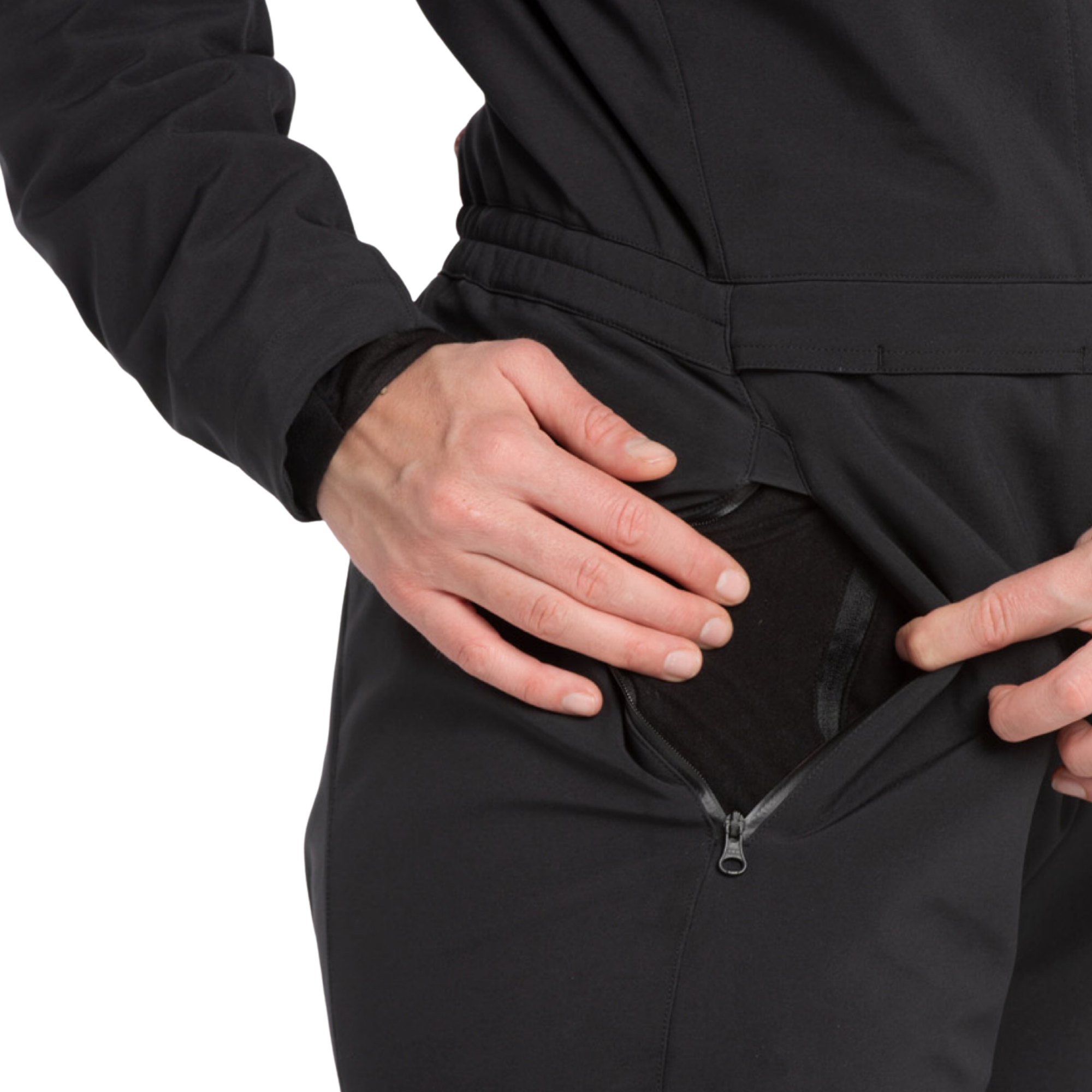 Close-up of a person wearing a black zippered jacket or jumpsuit, pulling the side pocket open with both hands against a white background.