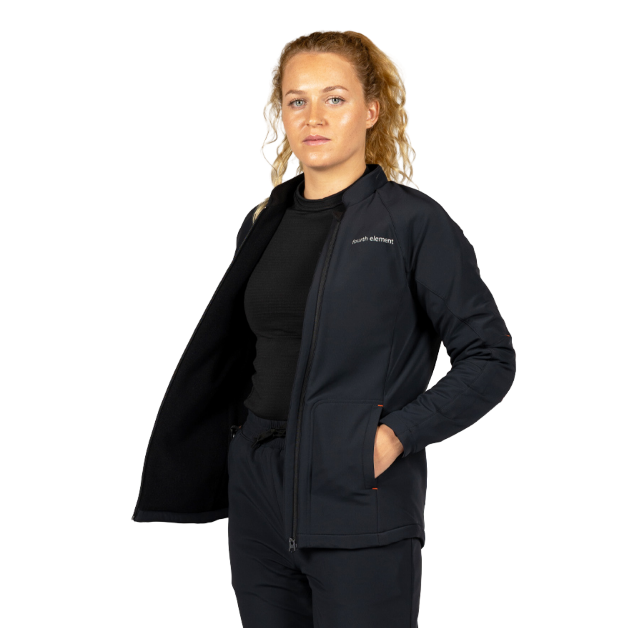 A woman modeling a black zip-up athletic jacket with a small white 'Sportførder' logo on the left chest, worn over a black top and black pants against a plain white background.