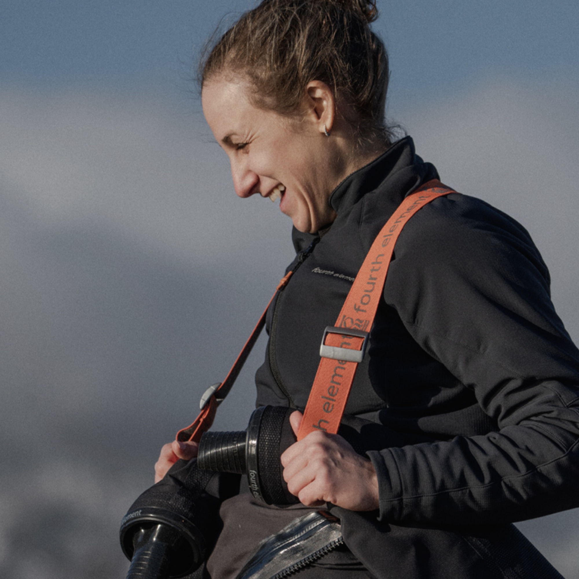 A woman outdoors wearing a black jacket 