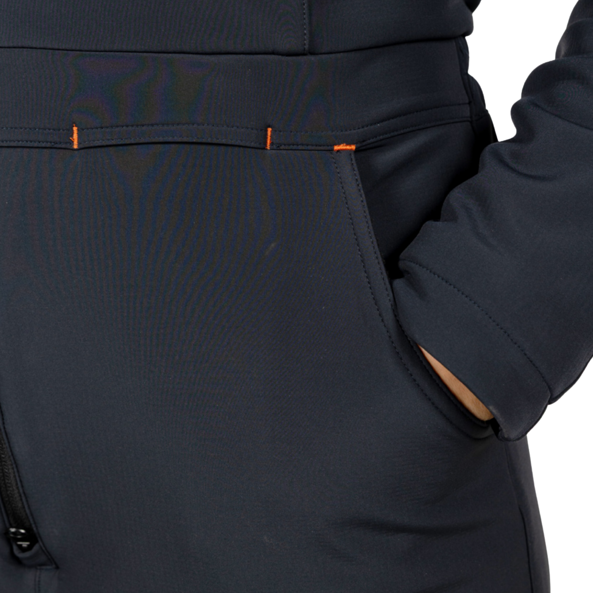 Close-up of a dark one piece showing a side pocket with a hand inside, featuring small orange accent stitching.