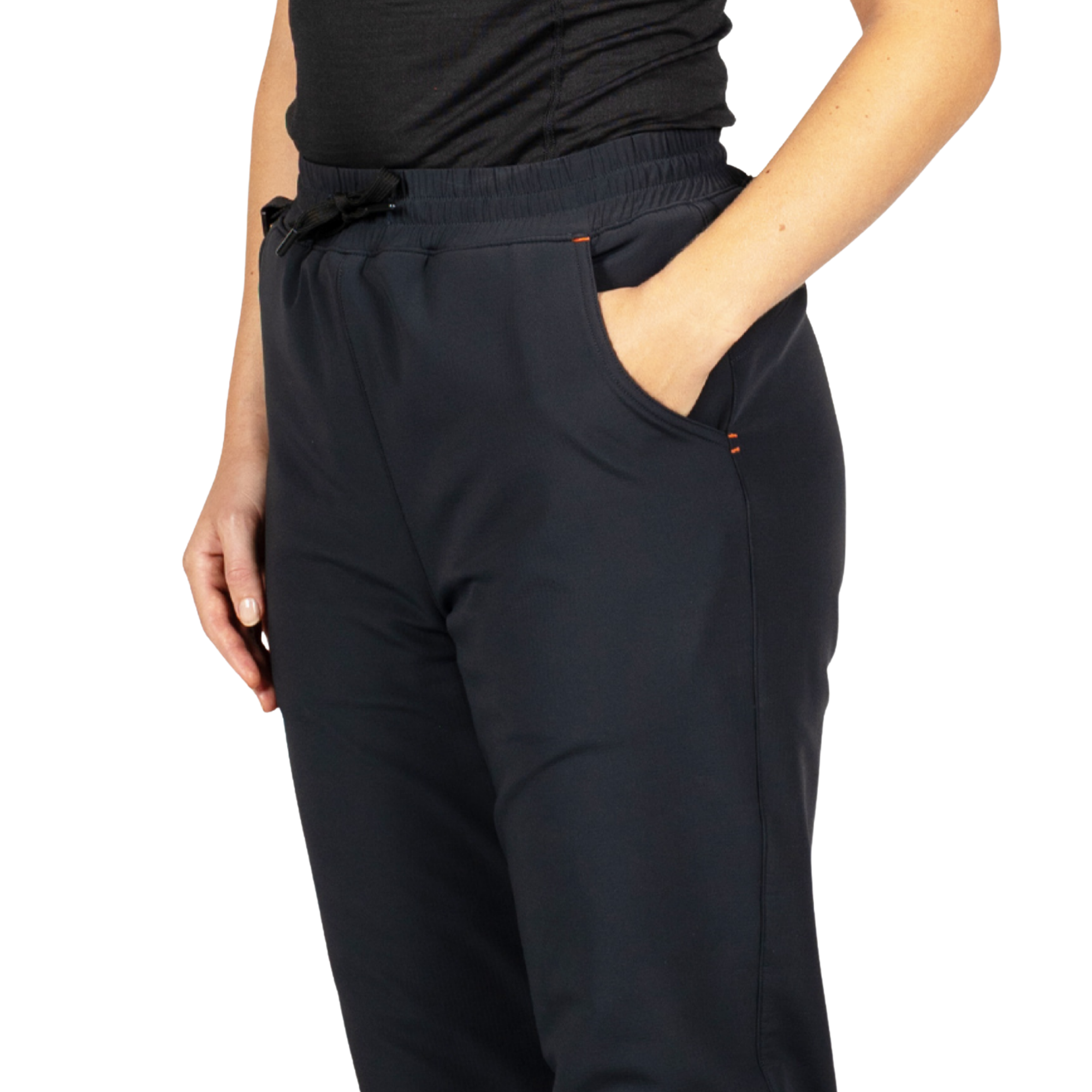 A close-up of a person wearing dark navy or near-black drawstring pants with side pockets, paired with a black top, against a plain white studio background.
