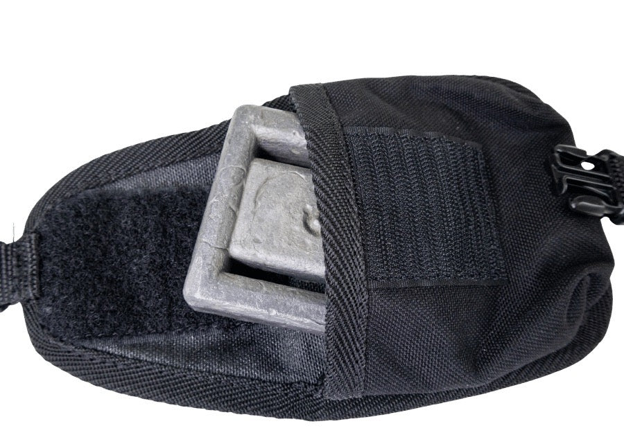 An open trim weight pocket in black with weight, white background