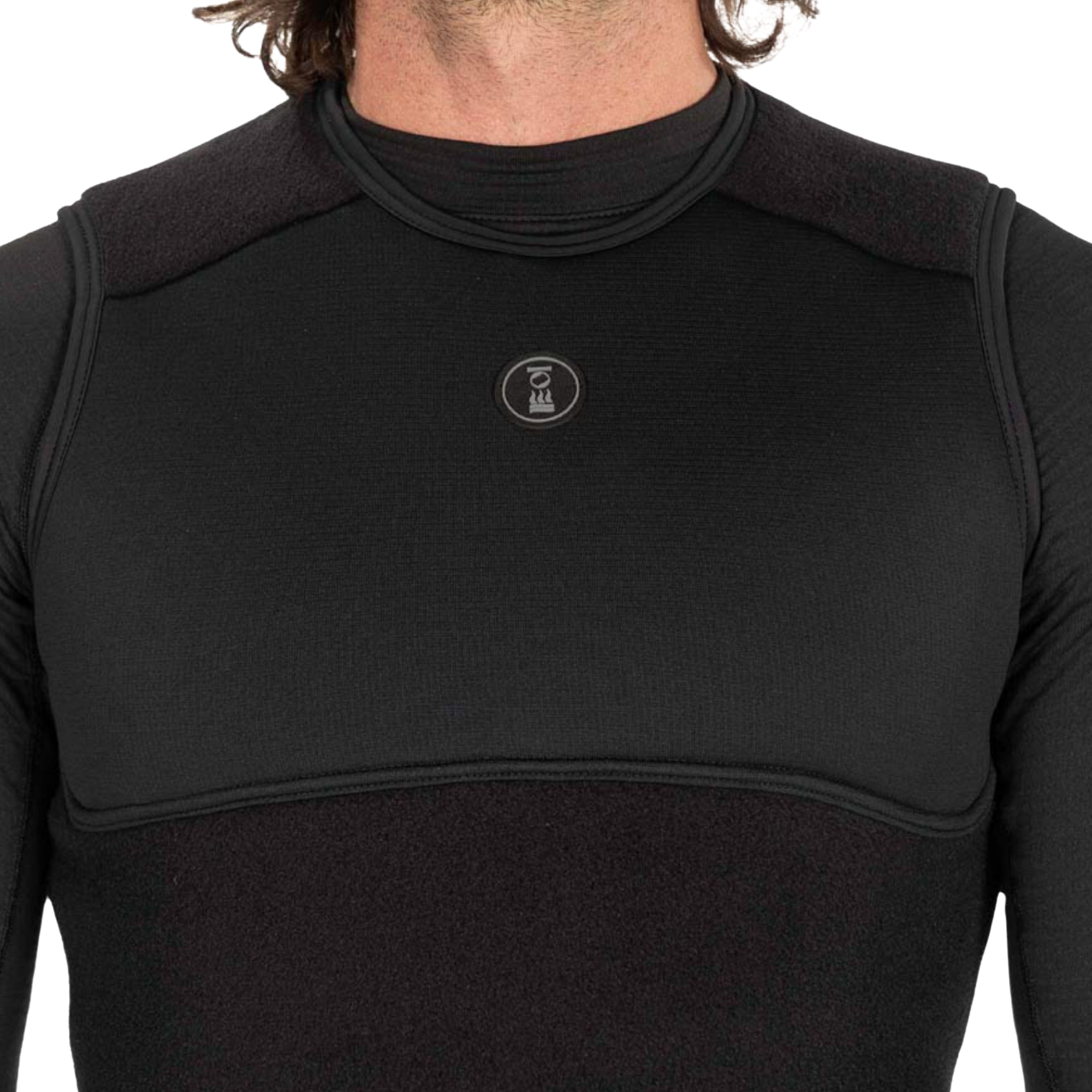 Close-up of a person wearing a black long-sleeve compression top with a mock neck, textured knit body, and a small circular ZM logo on the chest.