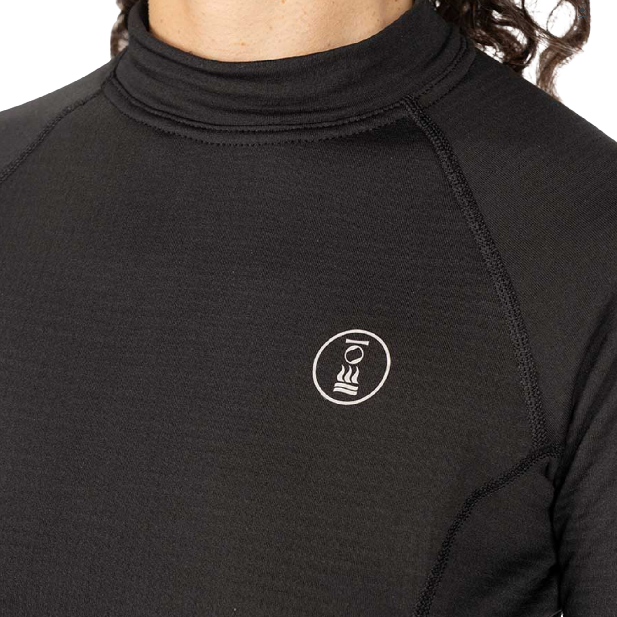 Close-up of a person wearing a black long-sleeve mock neck performance top with a small white circular logo on the left chest.
