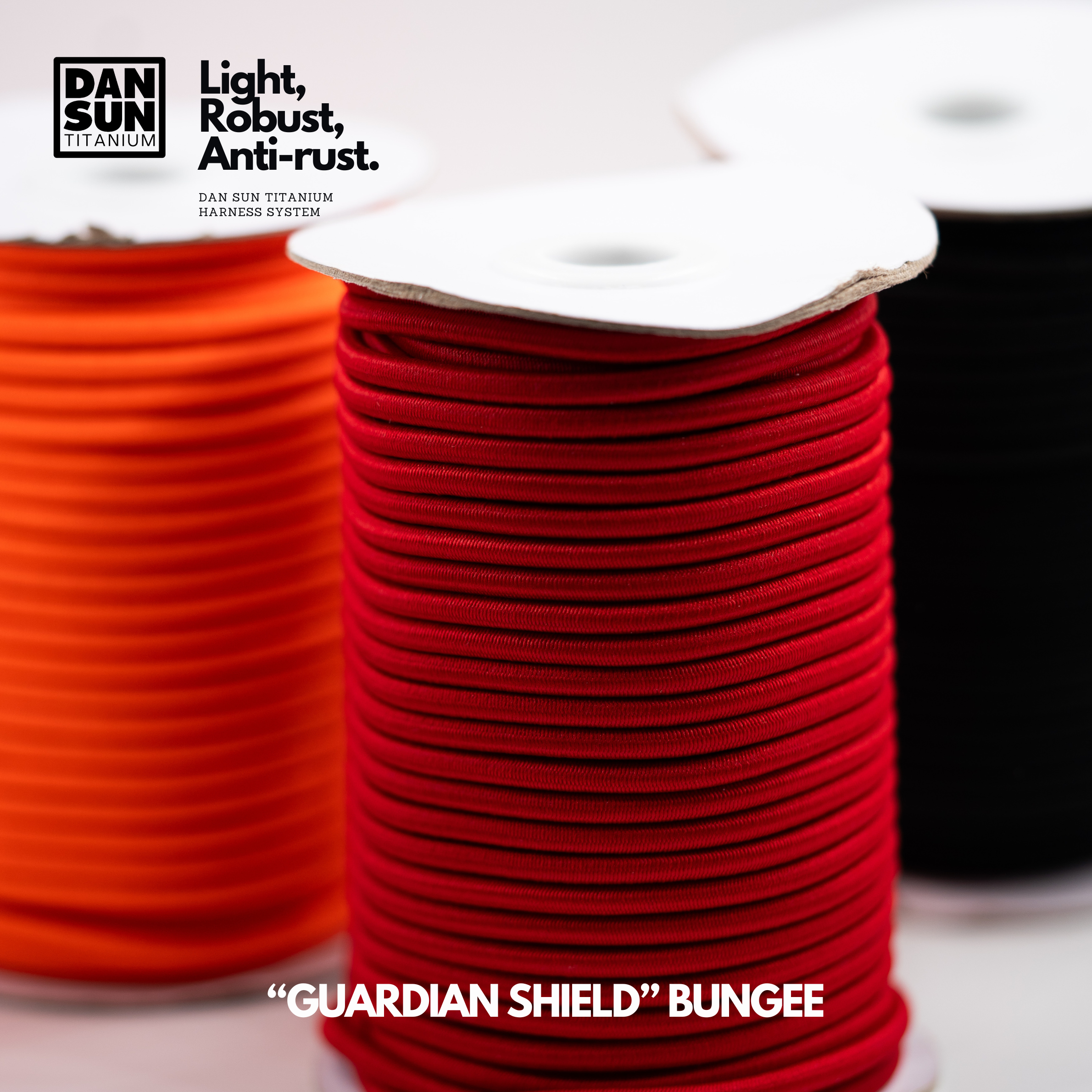 Orange, red and black bungee cord on rolls