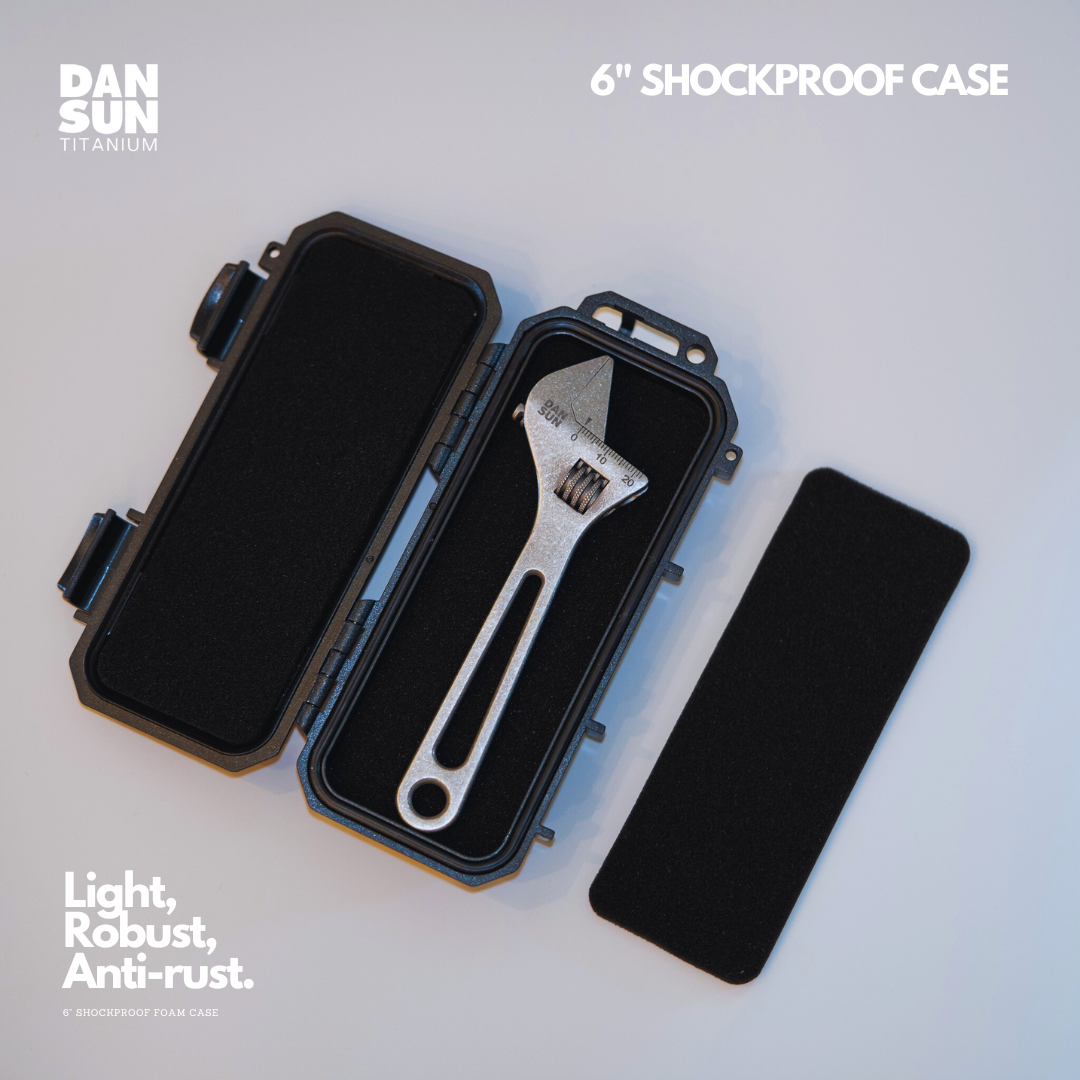Black case open with a titanium spanner and foam layers