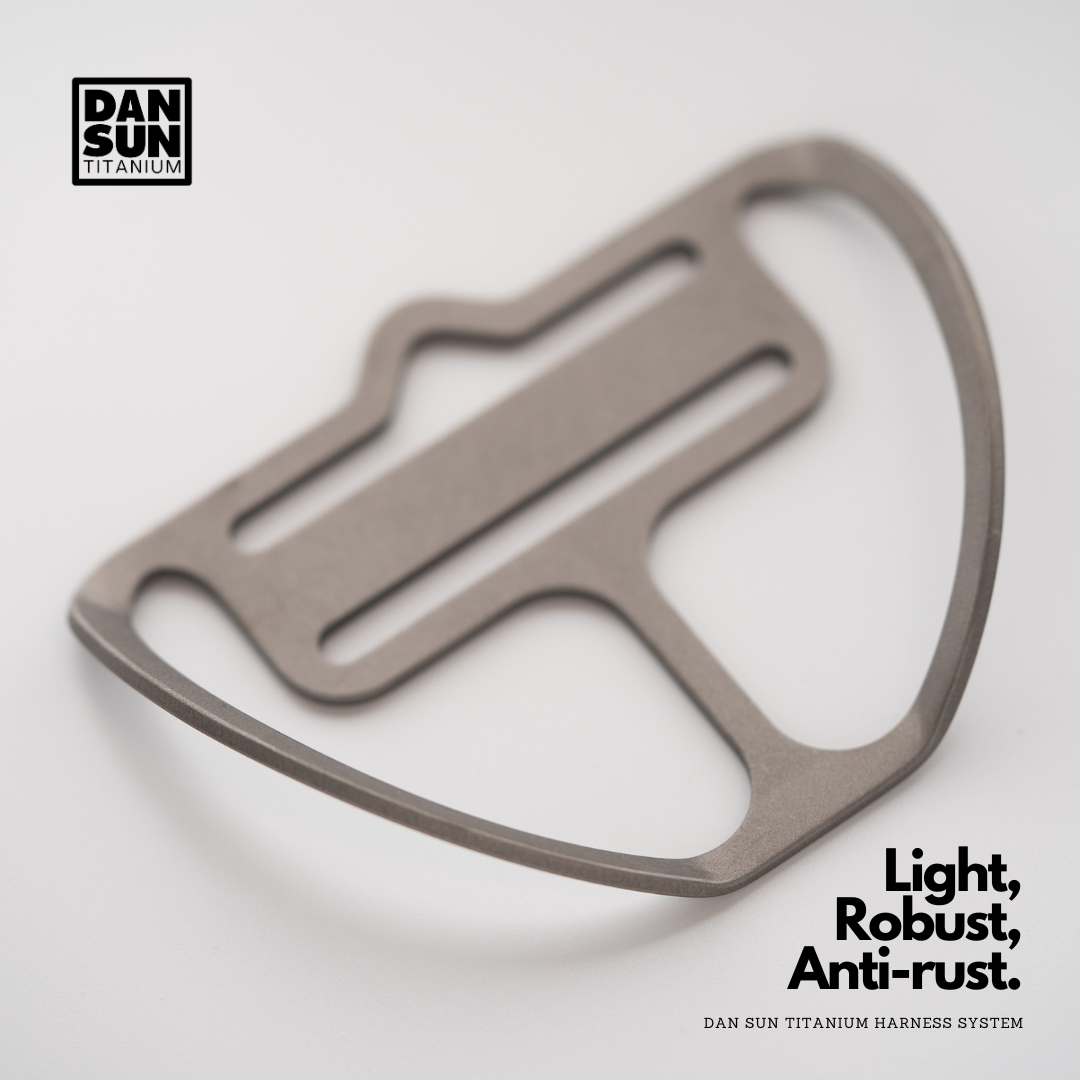 Titanium double port tri-glide with D-ring, angled view